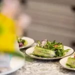 a group of plates of food designed by an event planner